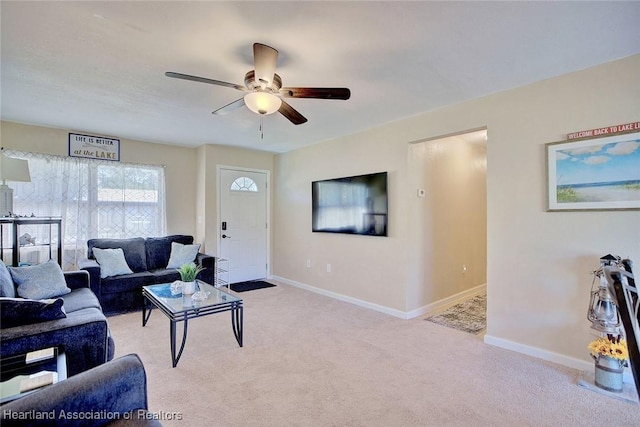 carpeted living room with ceiling fan