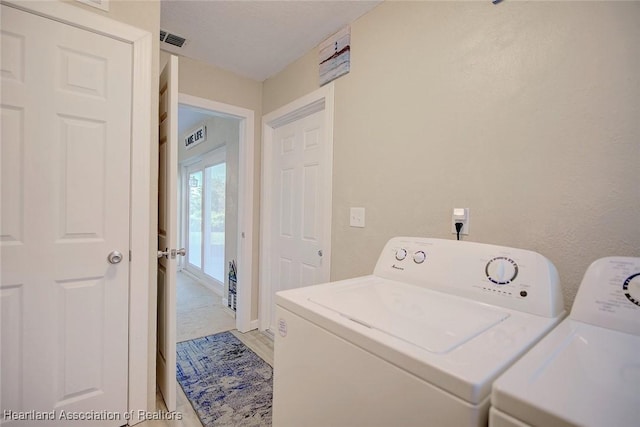 laundry room with hardwood / wood-style flooring and washer and clothes dryer