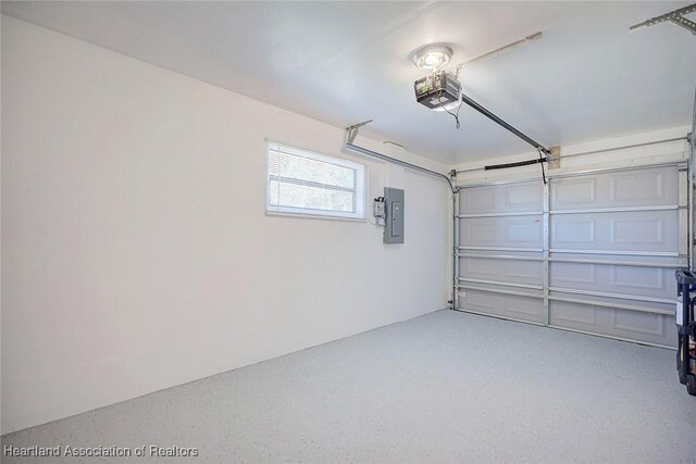 garage with a garage door opener and electric panel