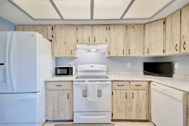 kitchen with white appliances and light brown cabinetry