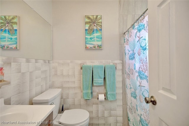 bathroom featuring tile walls, vanity, a shower with curtain, and toilet