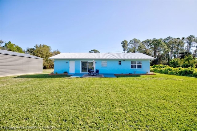 back of property with a patio and a yard