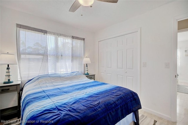 bedroom with ceiling fan and a closet