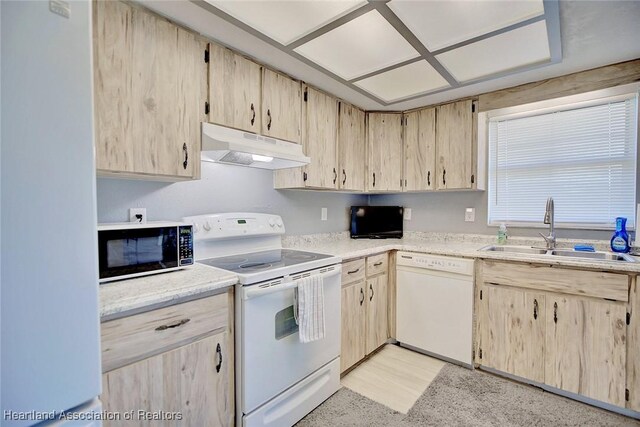 kitchen with white appliances, sink, and light brown cabinets