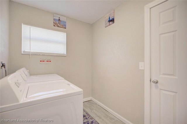 washroom featuring light hardwood / wood-style flooring and washing machine and clothes dryer