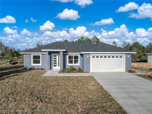 single story home with a garage and a front lawn