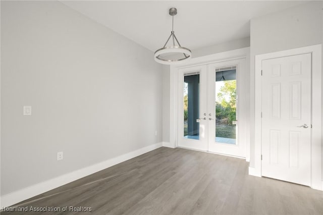 unfurnished room featuring french doors and wood-type flooring