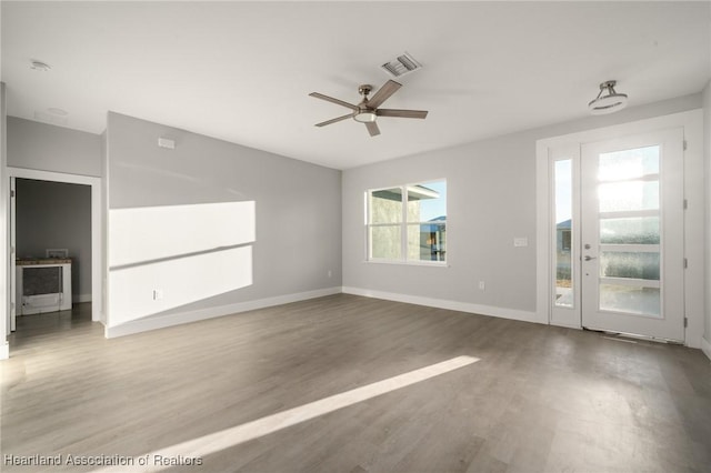 empty room with wood-type flooring and ceiling fan