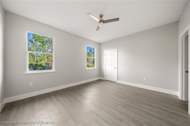 unfurnished bedroom featuring dark hardwood / wood-style flooring and ceiling fan