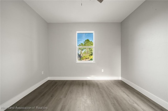 unfurnished room featuring dark wood-type flooring