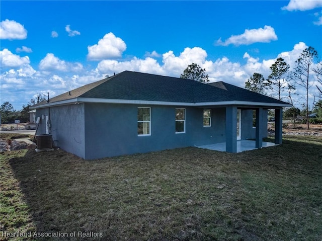 back of property featuring a lawn, a patio, and central air condition unit