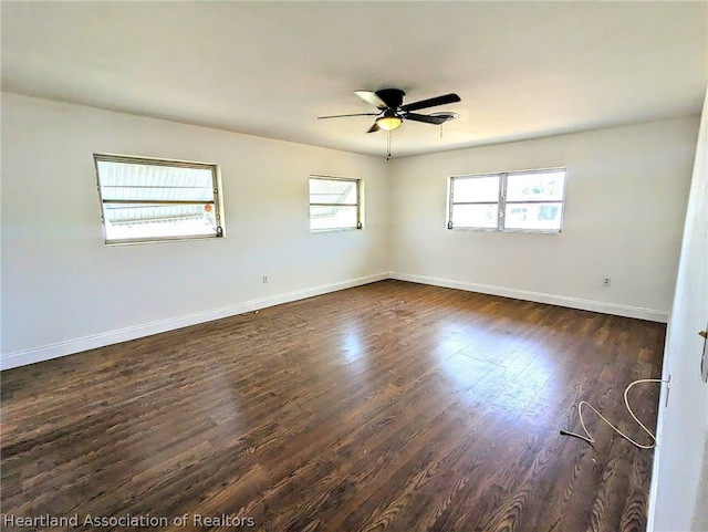 empty room featuring ceiling fan and dark wood-type flooring