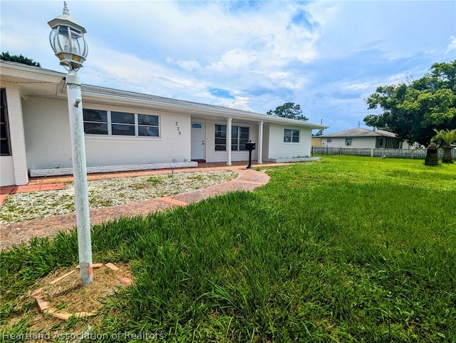 ranch-style home with a front lawn