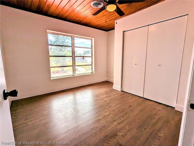 unfurnished bedroom with hardwood / wood-style flooring, ceiling fan, wood ceiling, and a closet