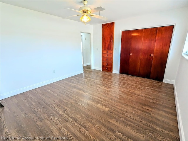 unfurnished bedroom with dark hardwood / wood-style floors and ceiling fan