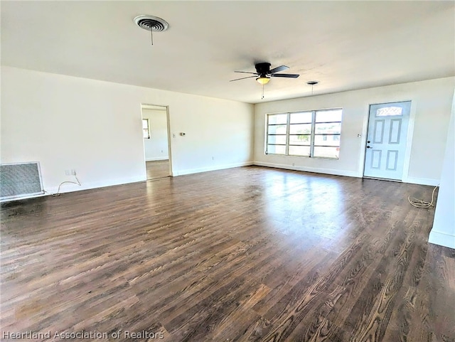 unfurnished living room featuring ceiling fan and dark hardwood / wood-style floors