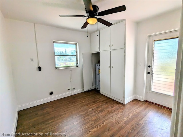 washroom with water heater, dark hardwood / wood-style flooring, and ceiling fan