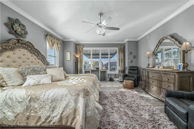 bedroom with hardwood / wood-style floors, ceiling fan, and ornamental molding