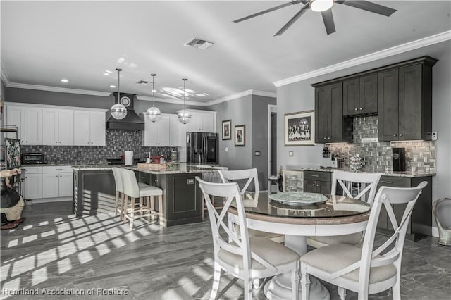 dining room with ceiling fan and crown molding