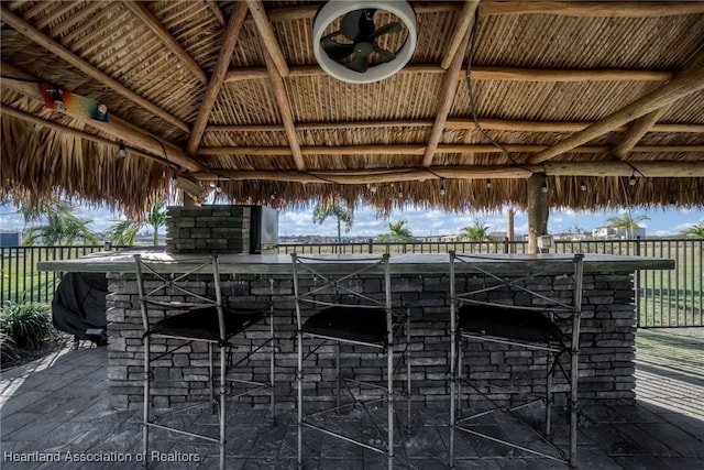 view of patio with a gazebo and an outdoor bar