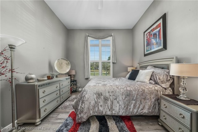 bedroom with ceiling fan and hardwood / wood-style floors