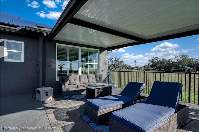 view of patio / terrace featuring an outdoor living space with a fire pit