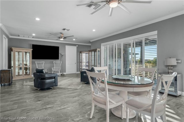 dining space featuring ceiling fan and crown molding