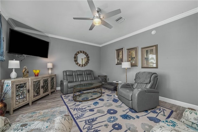 living room with hardwood / wood-style floors, ceiling fan, and ornamental molding