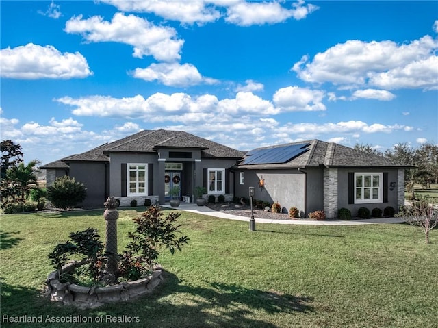 prairie-style home featuring solar panels and a front lawn