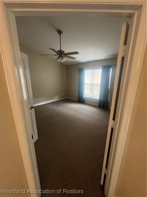 unfurnished room featuring carpet and ceiling fan