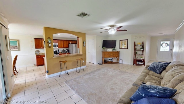 living room featuring ceiling fan and light tile patterned floors