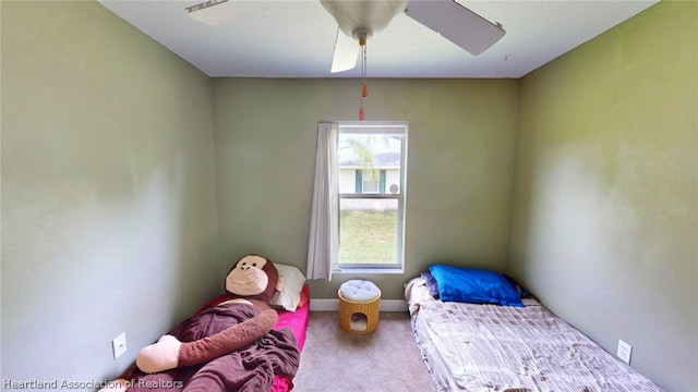 bedroom featuring ceiling fan and carpet