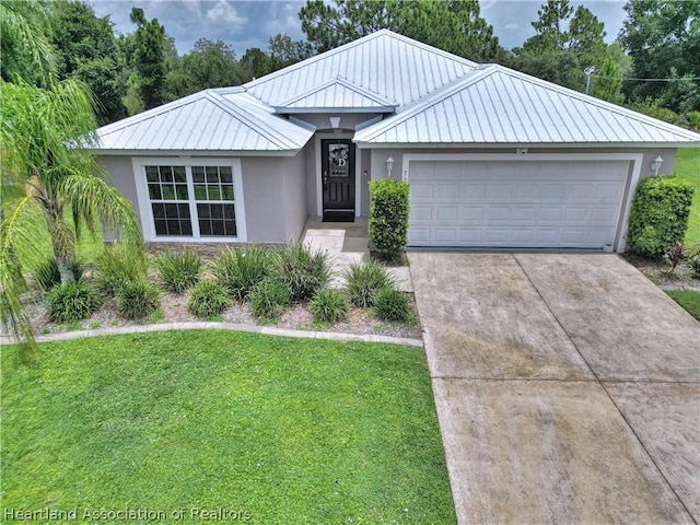 view of front of property featuring a garage and a front lawn