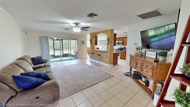 living room with ceiling fan, light tile patterned floors, and crown molding