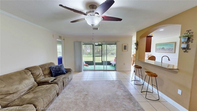 living room with ceiling fan and light tile patterned flooring