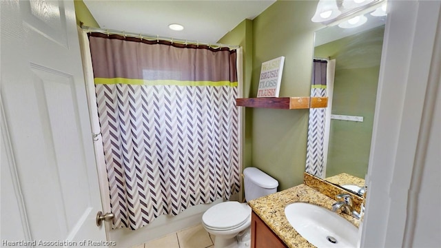 full bathroom featuring toilet, tile patterned floors, vanity, and shower / tub combo with curtain