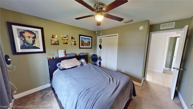 carpeted bedroom with ceiling fan and a closet