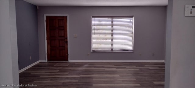 spare room with dark hardwood / wood-style floors