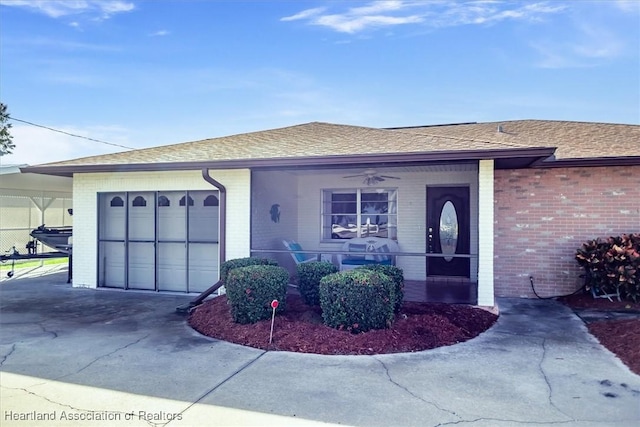 view of front of property with a garage and ceiling fan