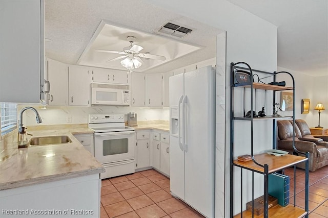 kitchen featuring sink, white cabinetry, white appliances, and light tile patterned floors