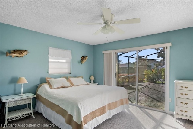 bedroom featuring ceiling fan, carpet flooring, access to exterior, and a textured ceiling