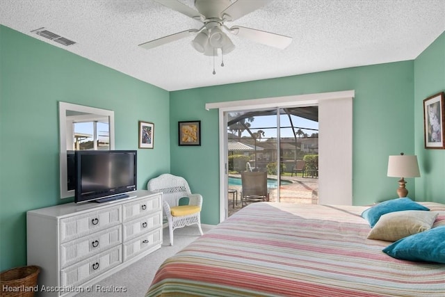 carpeted bedroom with a textured ceiling, ceiling fan, and access to outside