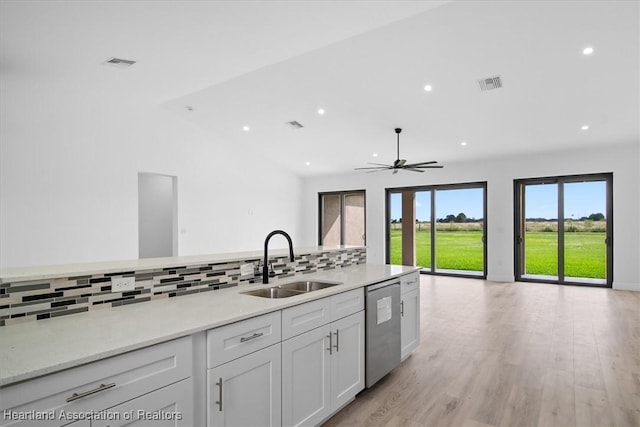 kitchen featuring sink, white cabinetry, tasteful backsplash, light hardwood / wood-style flooring, and dishwasher