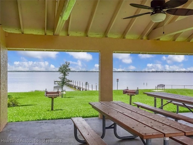 view of property's community featuring a lawn and a water view