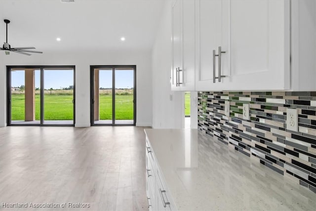 unfurnished living room featuring ceiling fan and light hardwood / wood-style floors