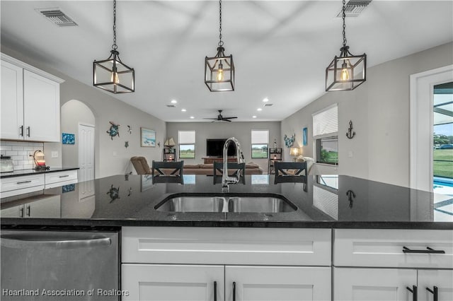 kitchen with white cabinetry, stainless steel dishwasher, sink, and hanging light fixtures