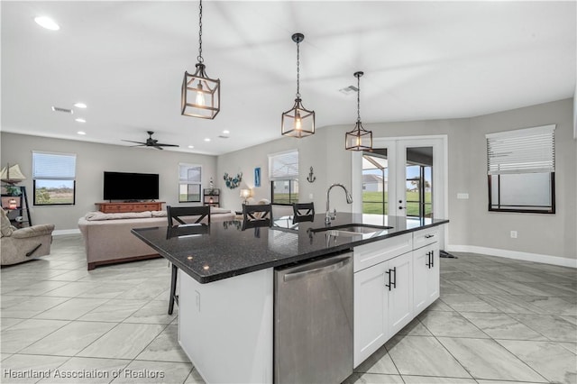 kitchen with sink, dishwasher, an island with sink, pendant lighting, and white cabinets