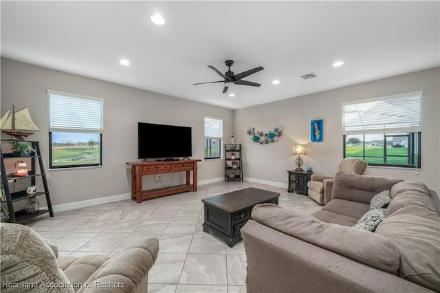 living room with a wealth of natural light and ceiling fan