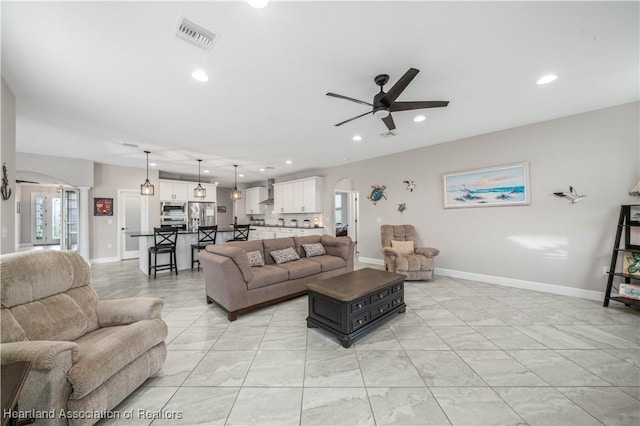 tiled living room with ceiling fan