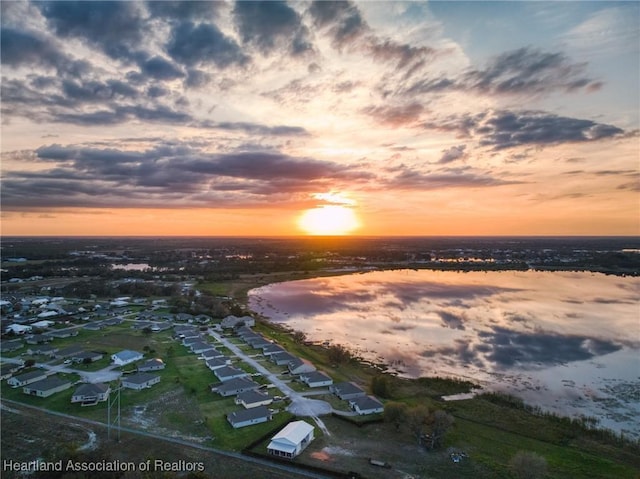 aerial view at dusk with a water view